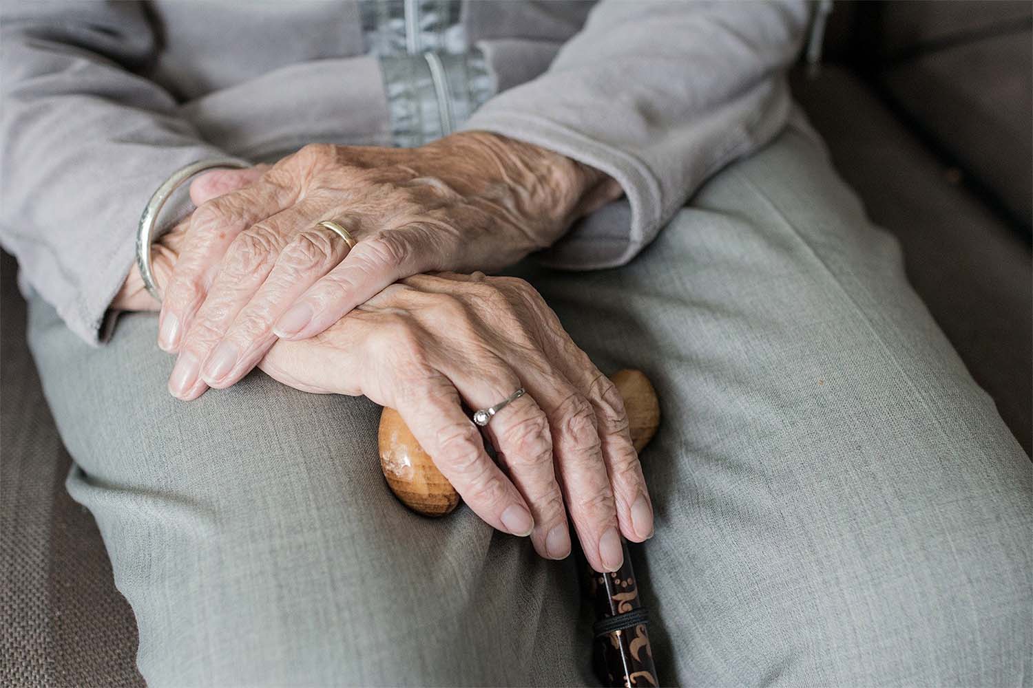 A resident holding a walking stick