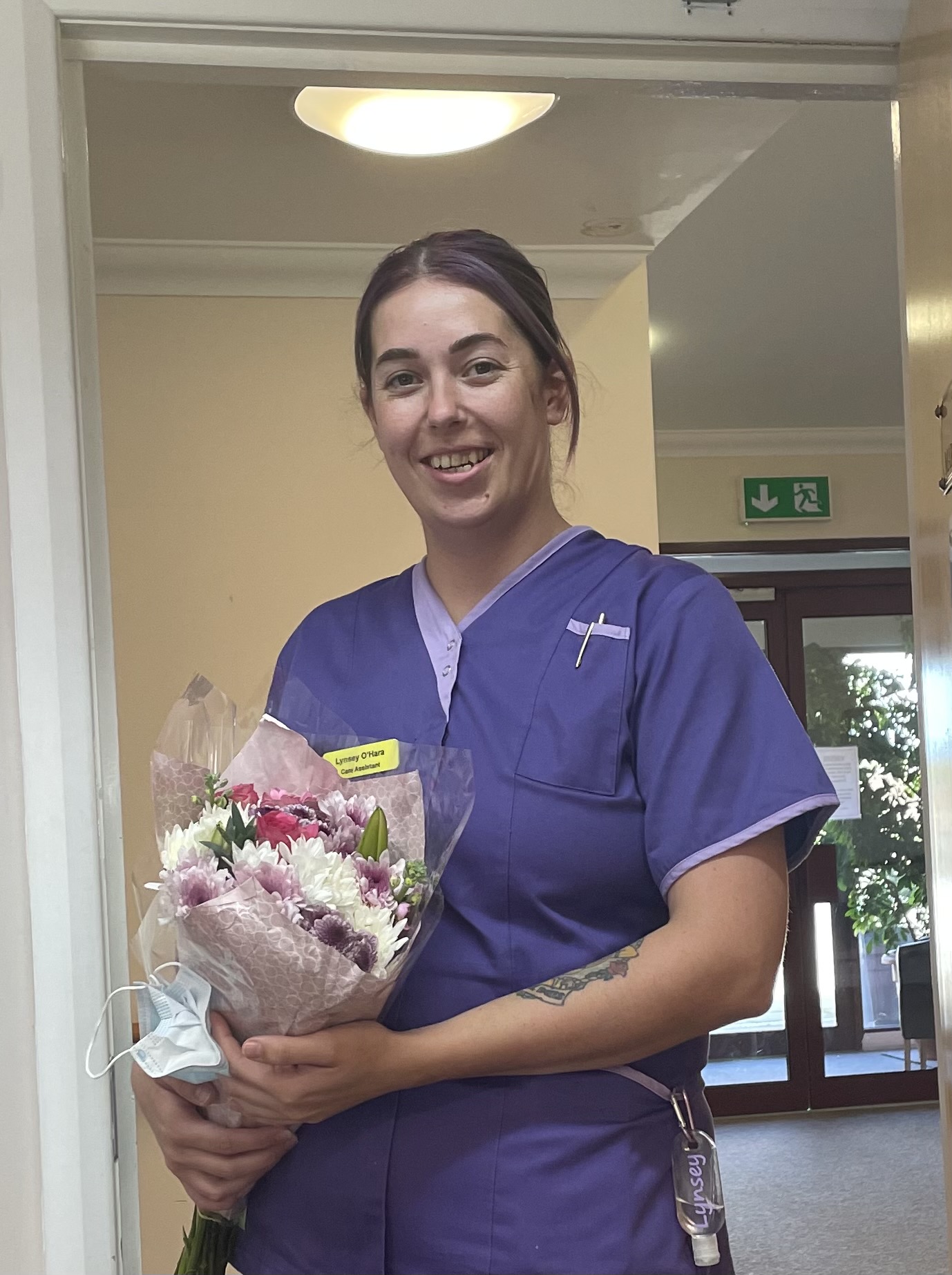 Lynsey, Senior Care Assistant Holding Flowers