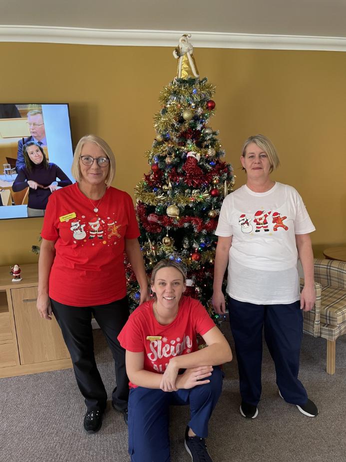 staff-infront-of-christmas-tree