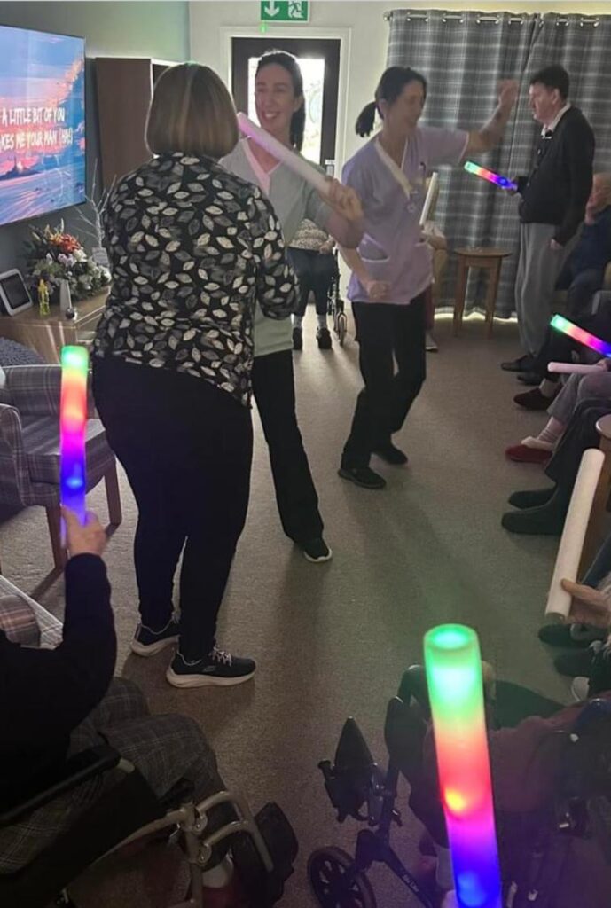 staff-and-residents-dancing-with-glow-sticks