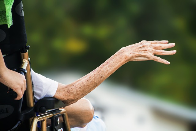 older lady's arm in short sleeves reaching out