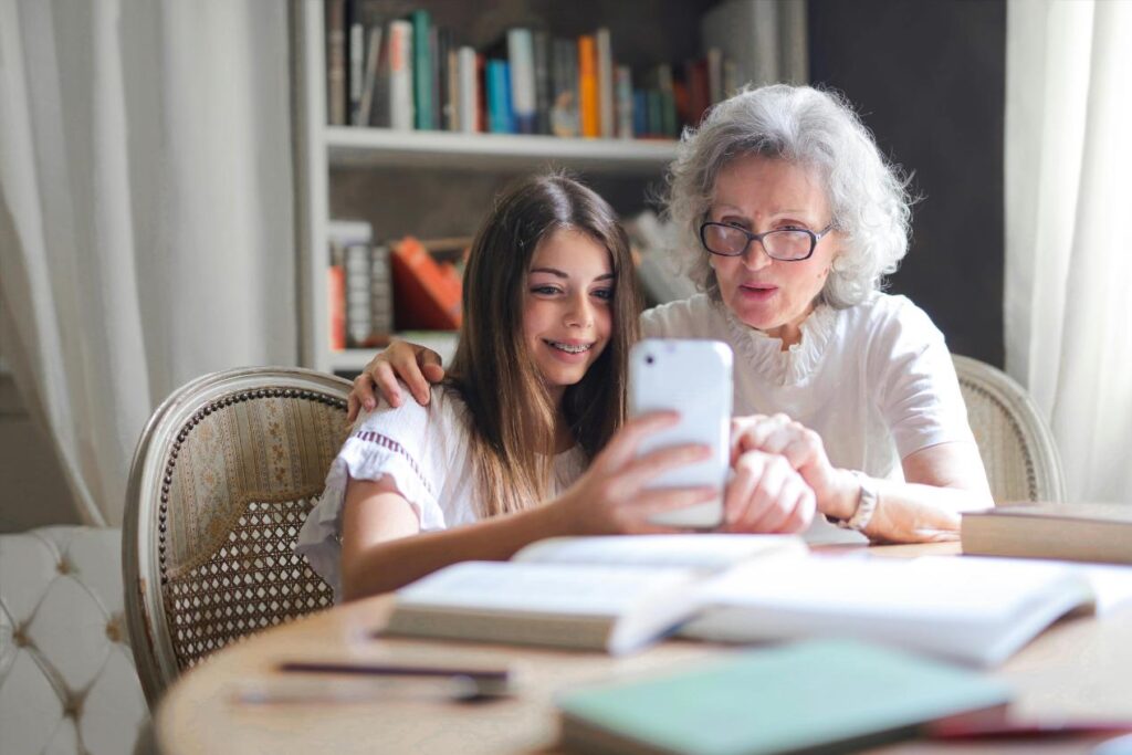 woman-with-grandaughter-looking-at-a-phone