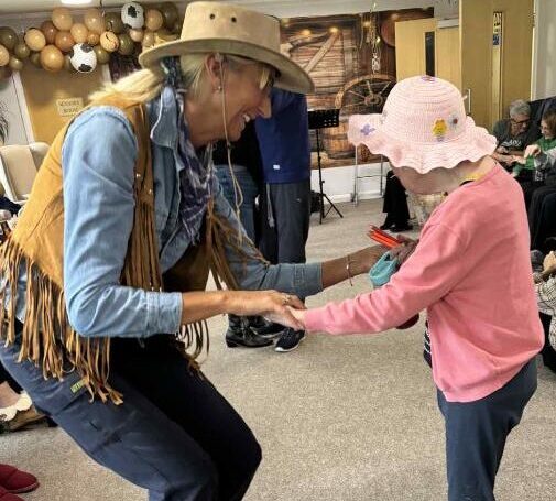 resident dancing with staff
