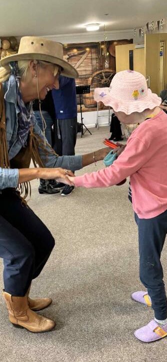 resident dancing with staff