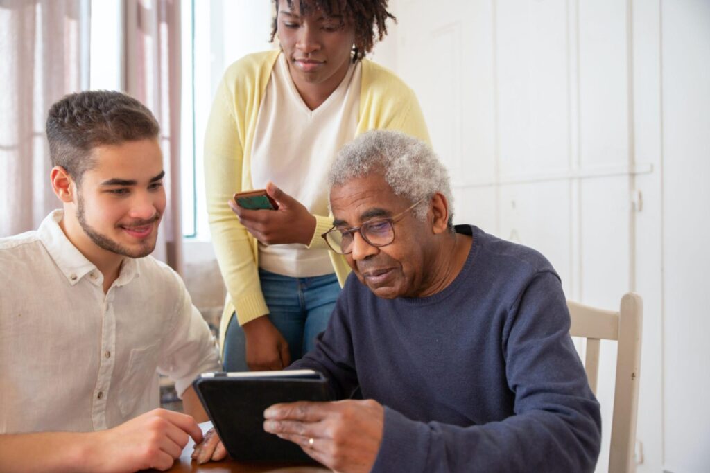 man helping his parents research care options on a tablet
