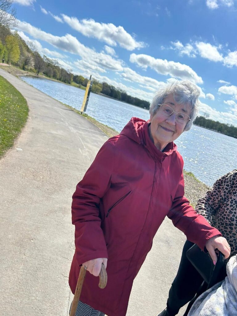 elderly woman on a lakeside walk