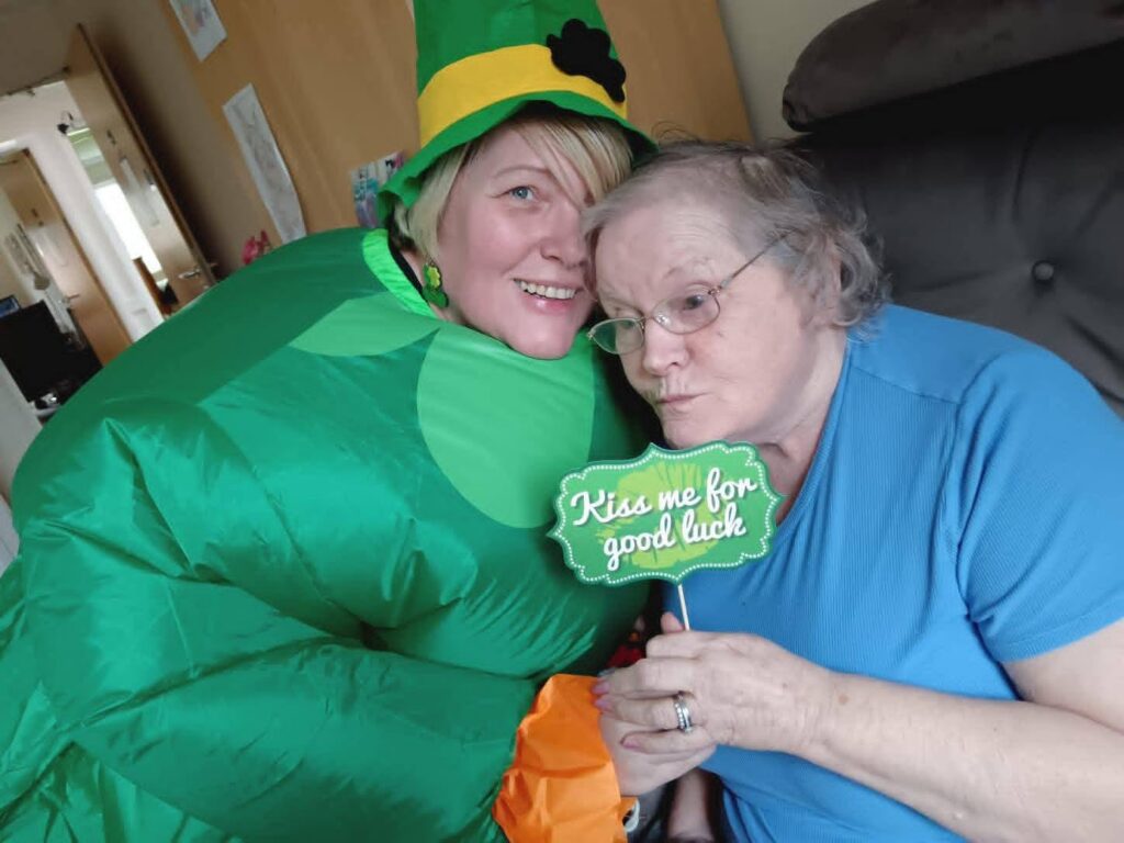 care home staff and resident celebrating st patricks day
