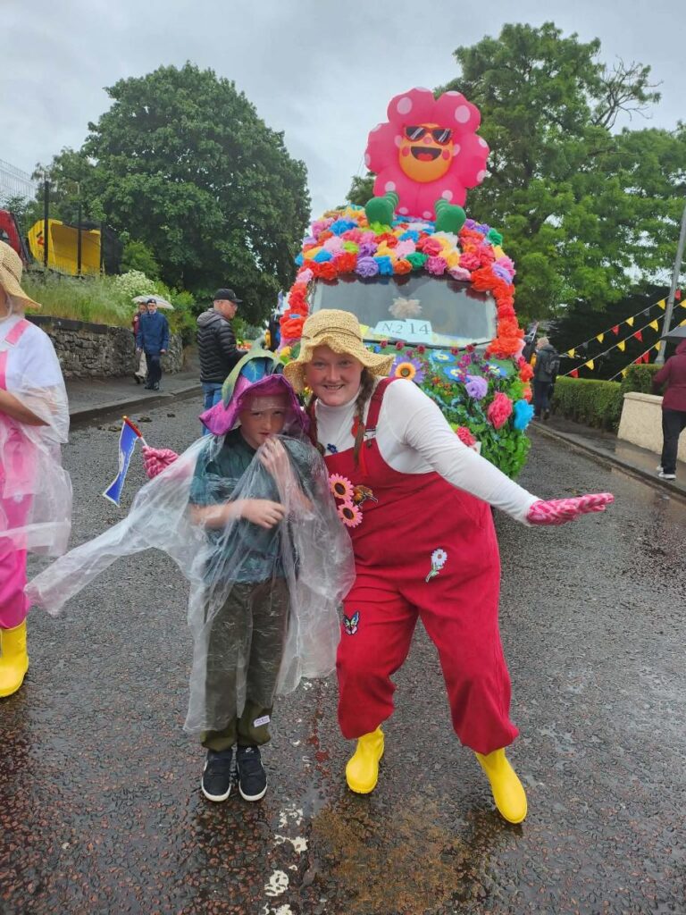 residents and staff dressed in colourful flowers on lanimers procession