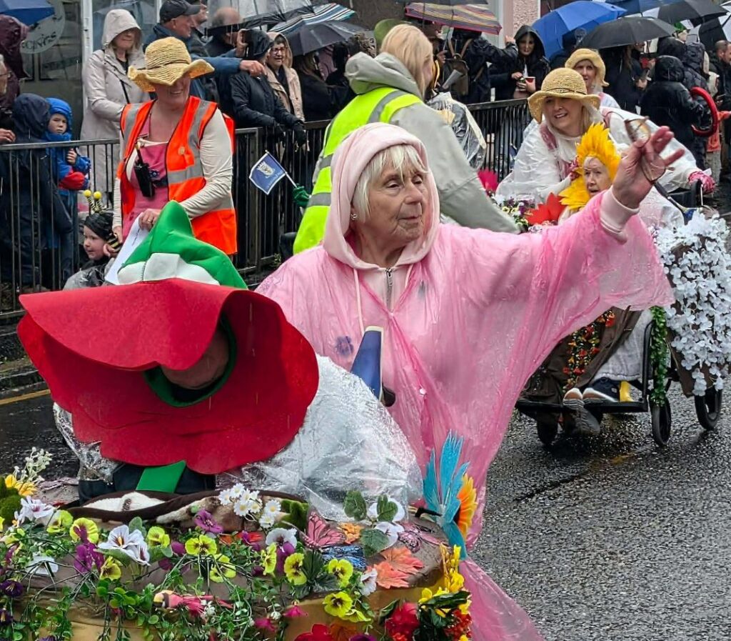 residents and staff dressed in colourful flowers on lanimers procession