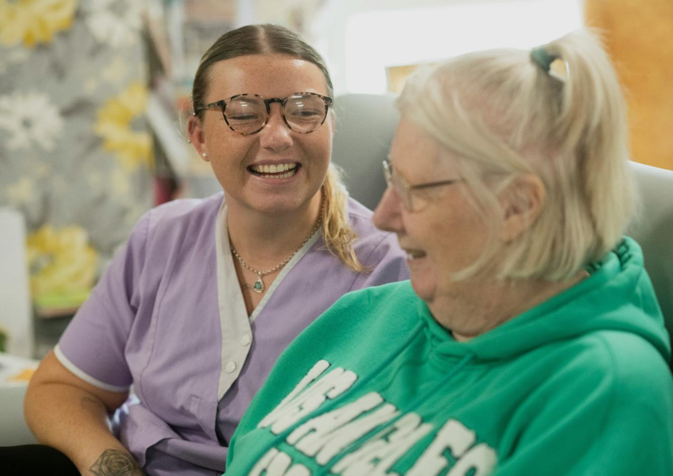 care home team member laughing with a resident