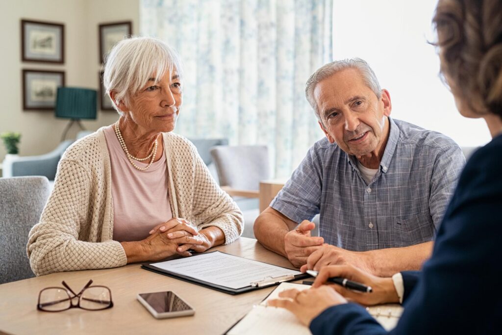elderly couple discussing care options in a care home